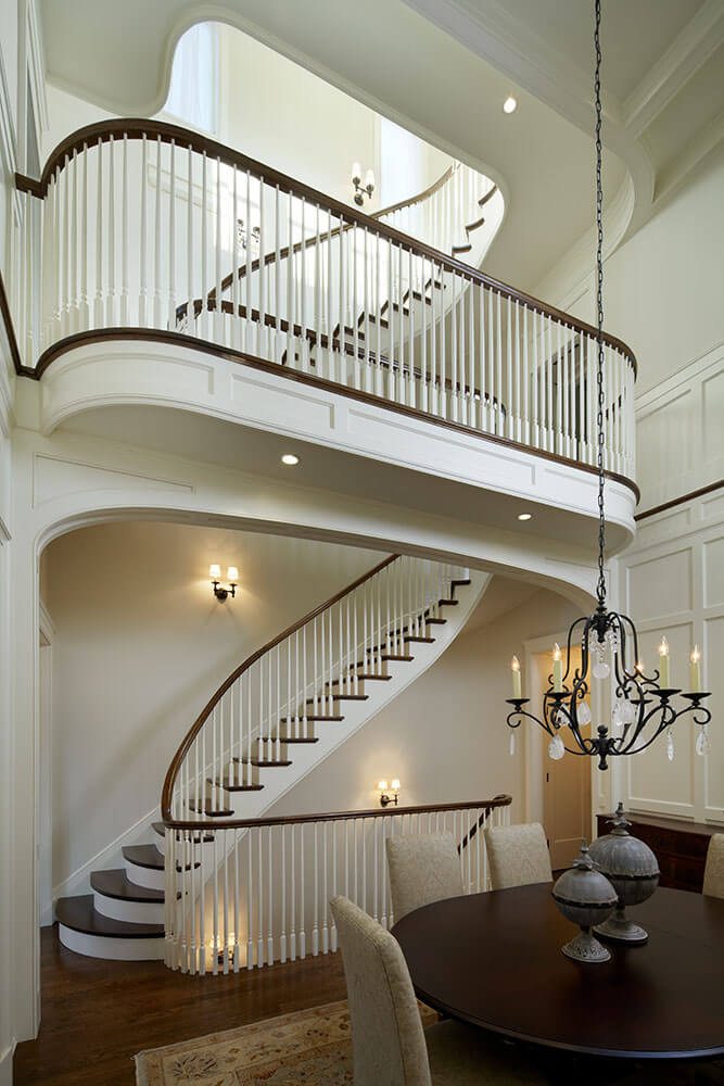 Double layer colonial style staircase with painted white and stained wooden parts