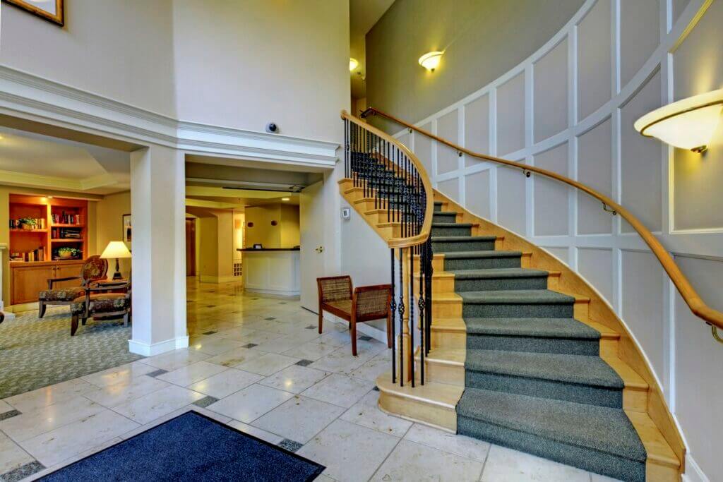 Circular Hard Maple Staircase with a gray staircase runner
