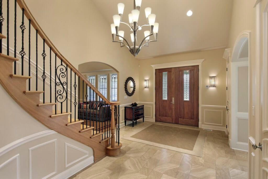 Light wood curved staircase with iron balusters