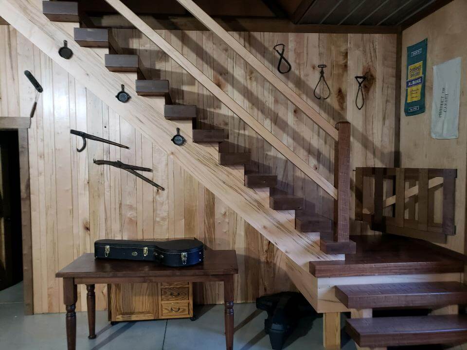 view of a rustic wooden staircase from the side
