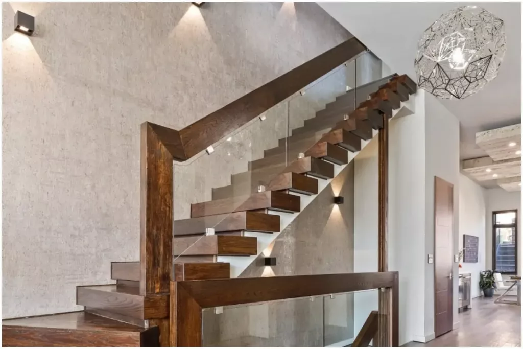 Wooden staircase with glass panels below the handrail